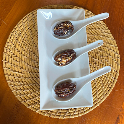 Medjool Dates - Sweet Medjool dates filled with almond butter and topped with orange zest, or with cashew butter and drizzled in rich cacao chocolate sauce.